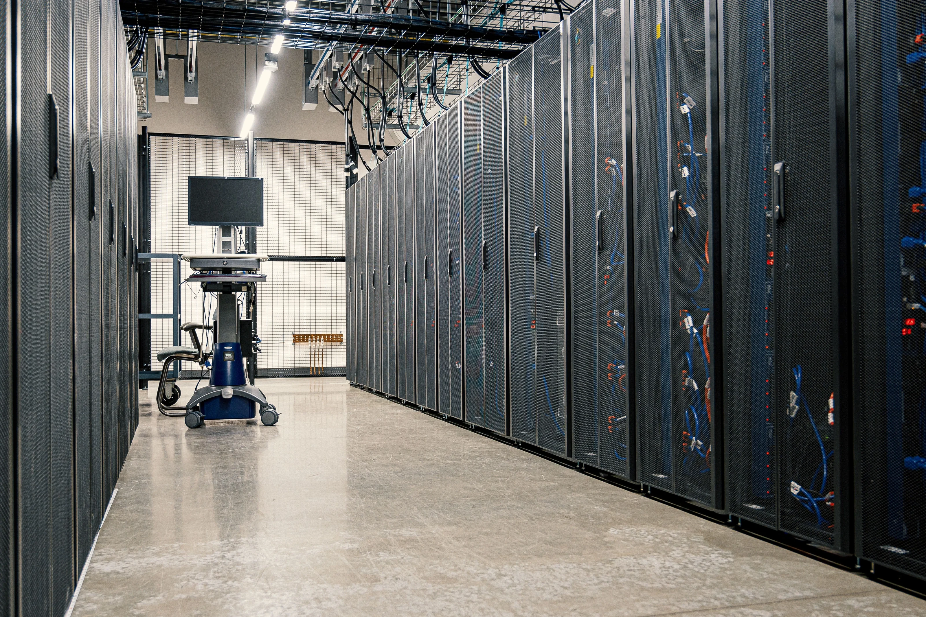 Data-centre corridor with server racks — illustrative sector photograph