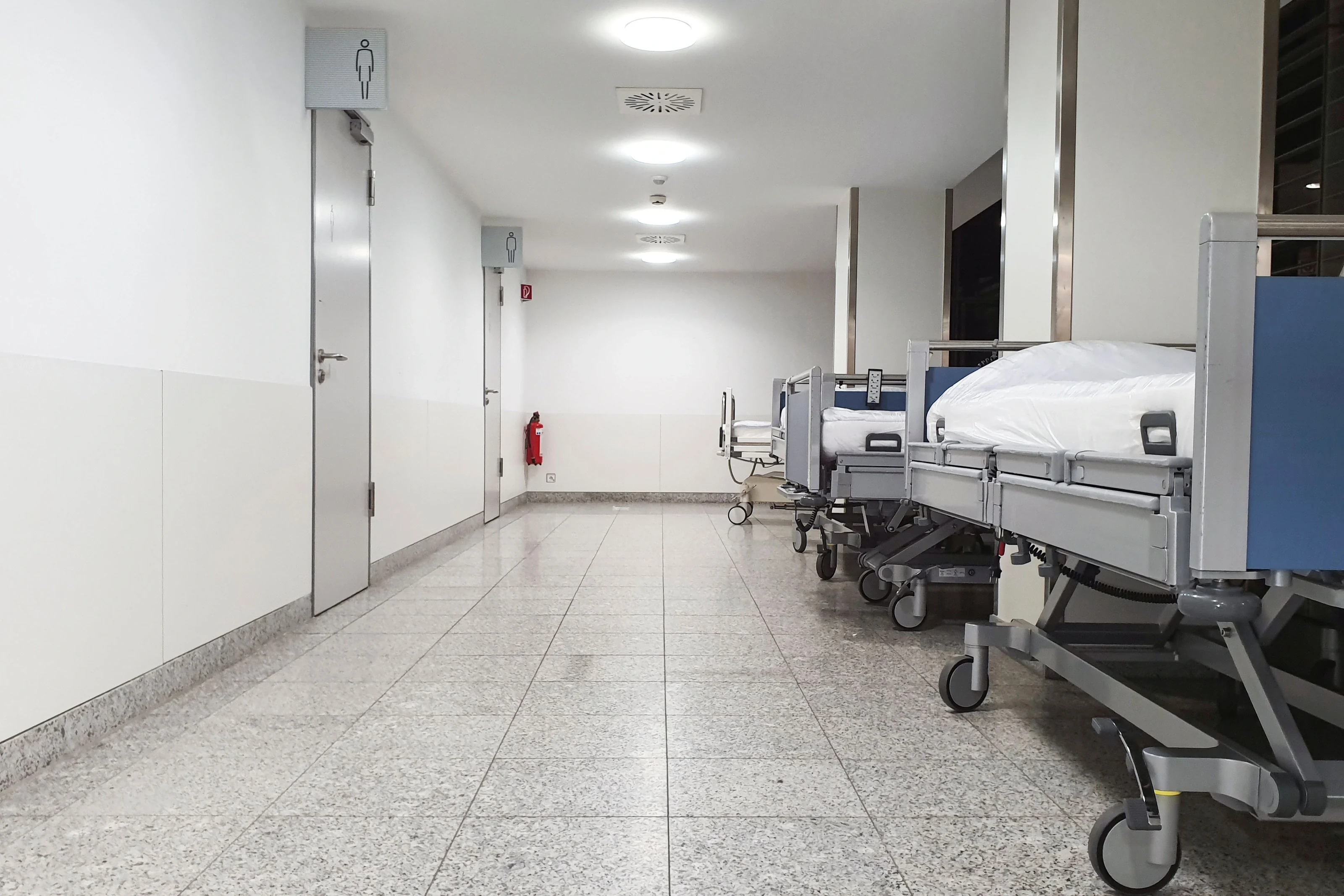 Hospital corridor and medical beds — illustrative sector photograph