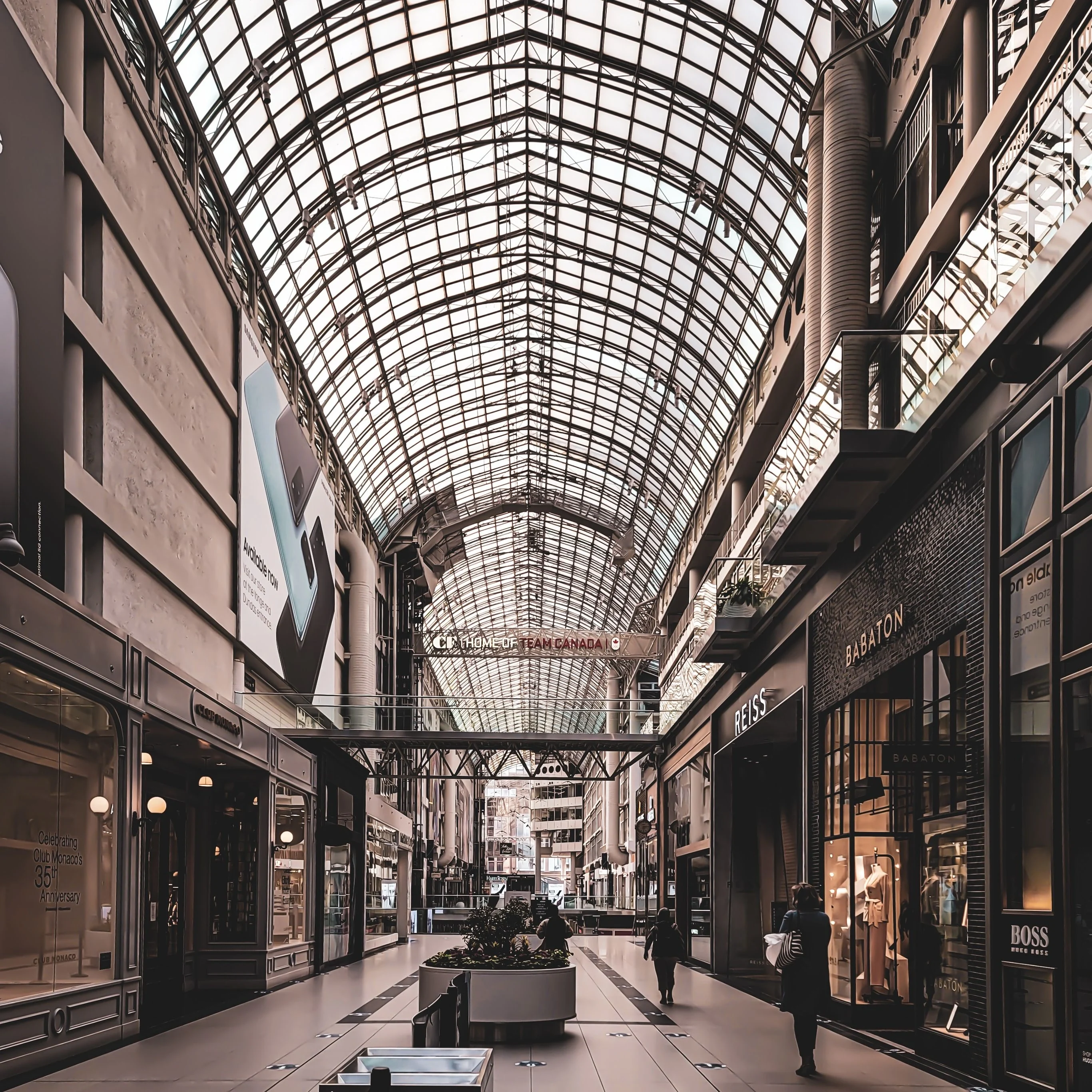 Interior of a shopping arcade with a glazed roof — illustrative sector photograph