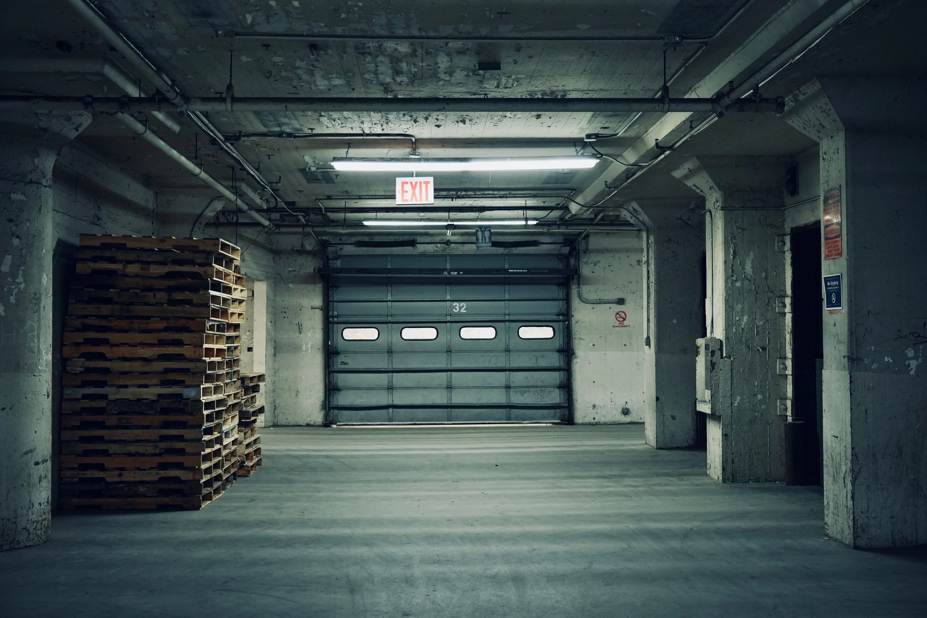 Vacant industrial building with a closed loading door — illustrative sector photograph